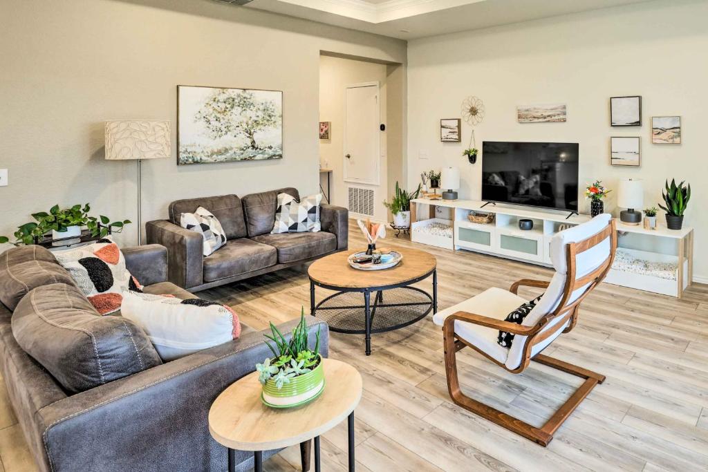 a living room with a couch and a tv at Sleek Fort Worth Home with Covered Patio! in Fort Worth