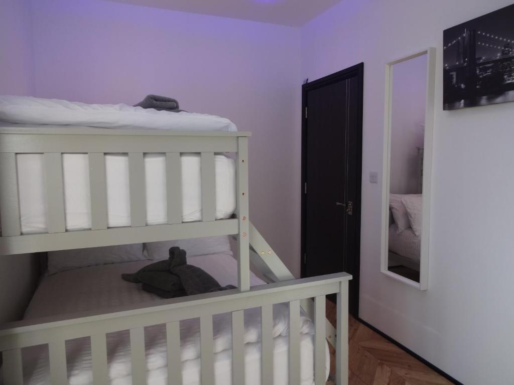 a baby room with a crib and a bunk bed at Bowness Bed & Breakfast Family Room, Bowness-on-Solway in Bowness-on-Solway