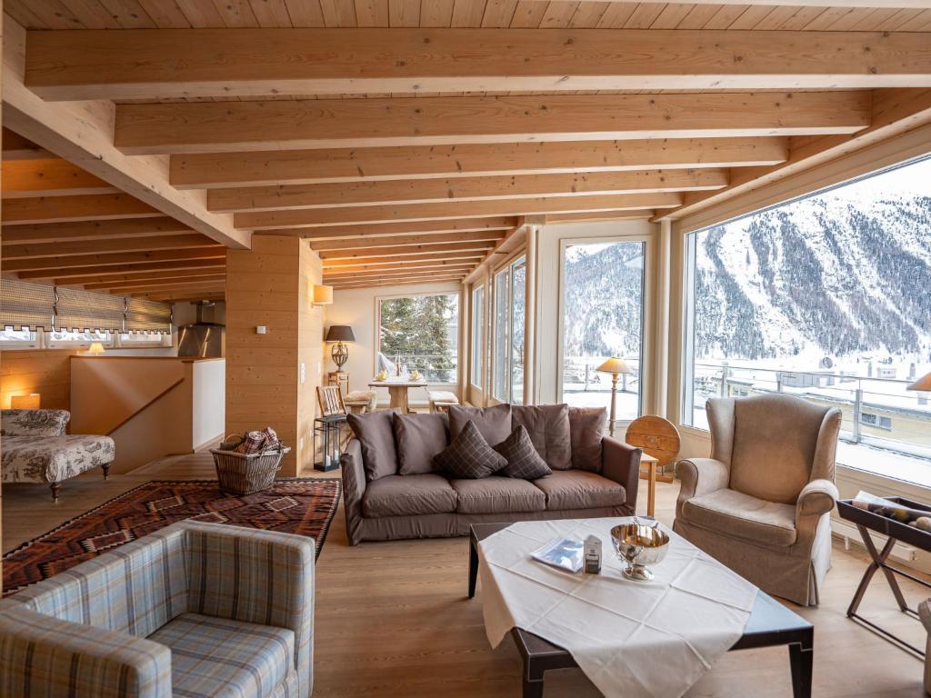 a living room with a couch and a table at Apartment Chesa Crusch 7 by Interhome in Samedan