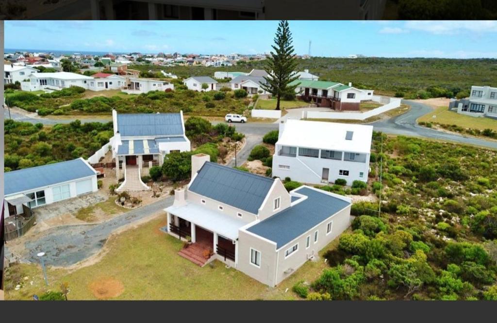 an aerial view of a large white house at Four Steenbras in Struisbaai