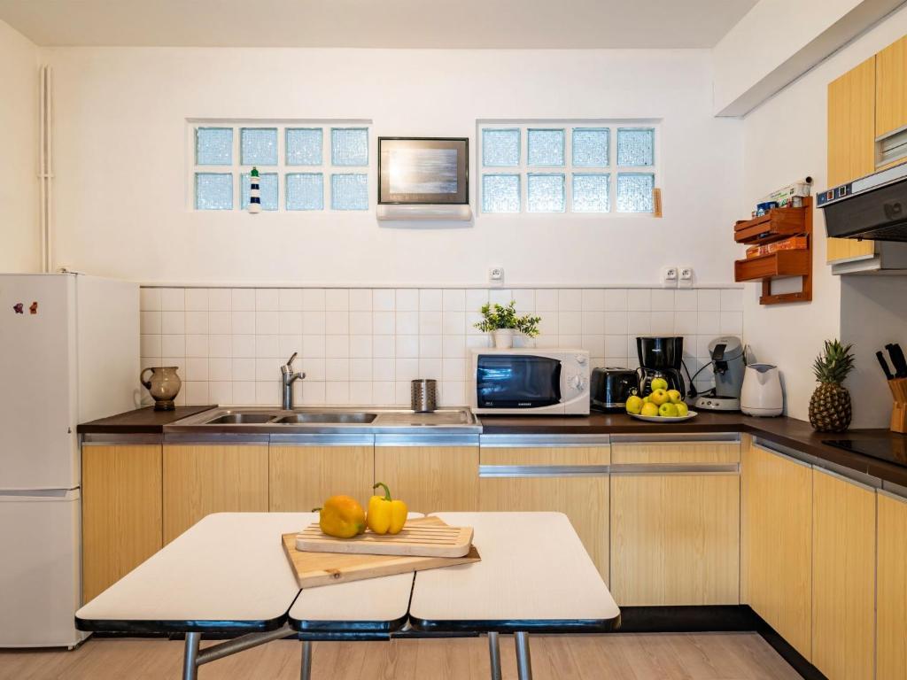 a kitchen with a table with fruit on it at Apartment Men Er Bellec-1 by Interhome in Saint-Philibert
