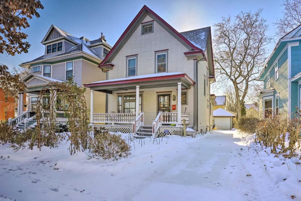 a house with snow on the ground in front of it at Charming Saint Paul Home with Yard, Near Downtown! in Saint Paul