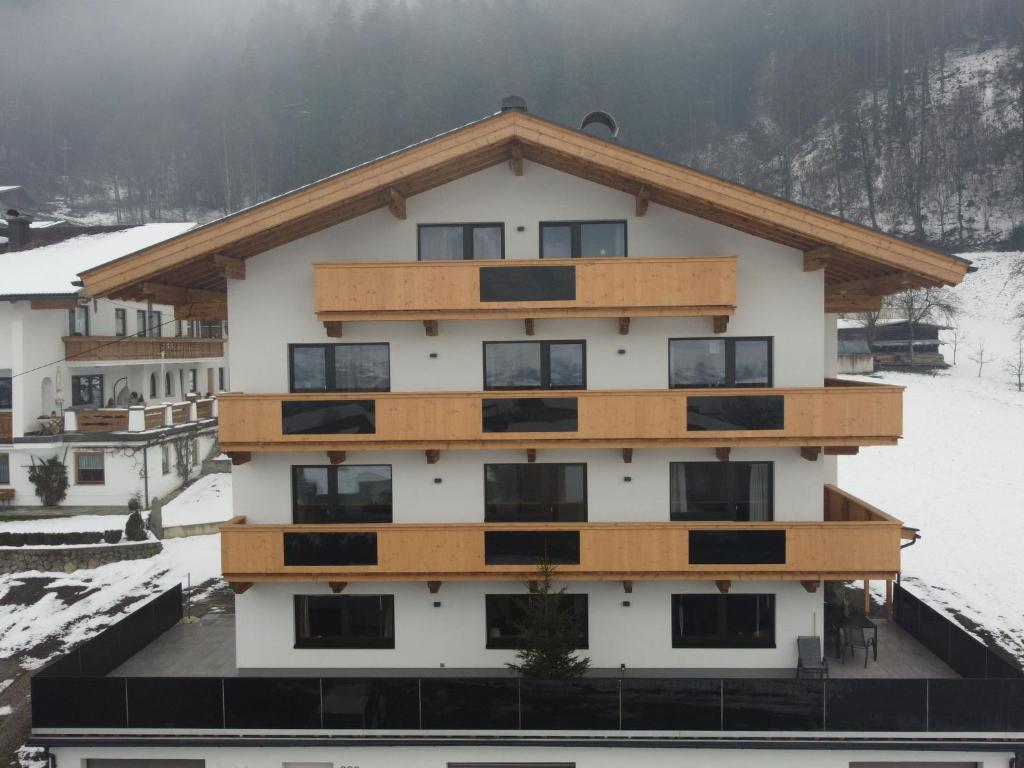 an apartment building with snow on the ground at Apartment Panoramablick by Interhome in Ramsau