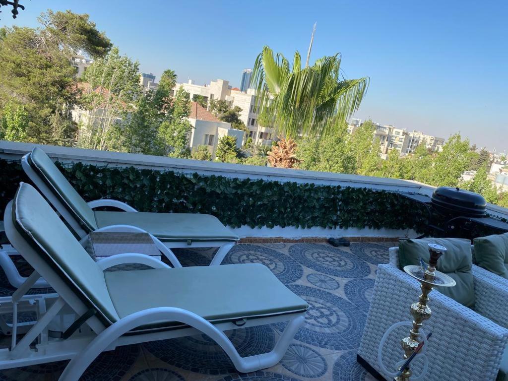 a group of chairs sitting on a patio at The view II in Amman