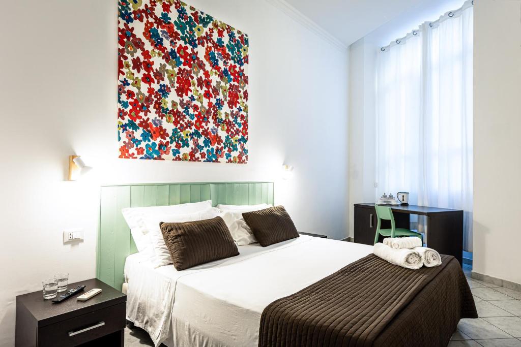 Łóżko lub łóżka w pokoju w obiekcie San Lorenzo Rooms