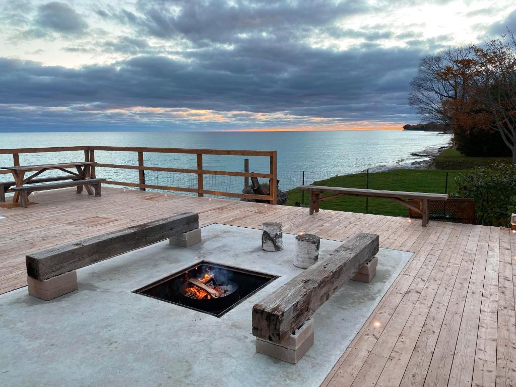 a fire pit on a deck next to the water at The Lakeside Motel in Wellington