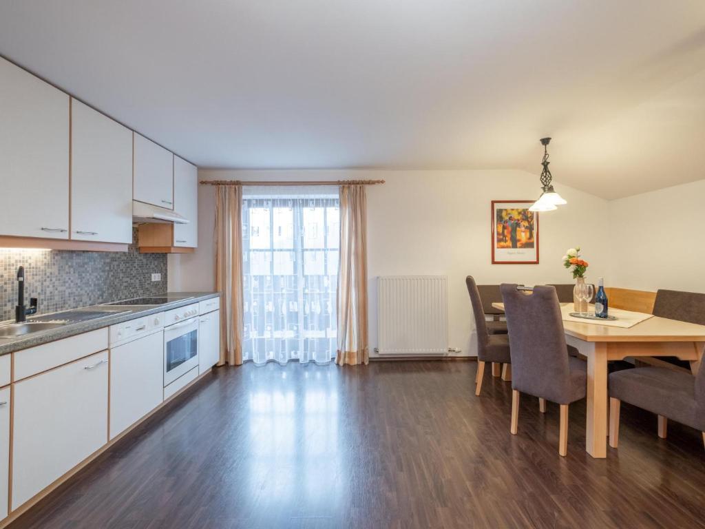 a kitchen and dining room with a table and chairs at Haus Durchegg OG in Wagrain