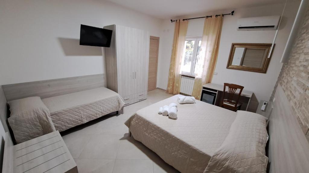 Postel nebo postele na pokoji v ubytování Hera Tropea Rooms