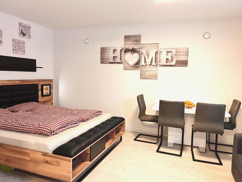 um quarto com uma cama, uma mesa e cadeiras em Ferienwohnung Brochenzell - nahe Ravensburger Spieleland em Meckenbeuren