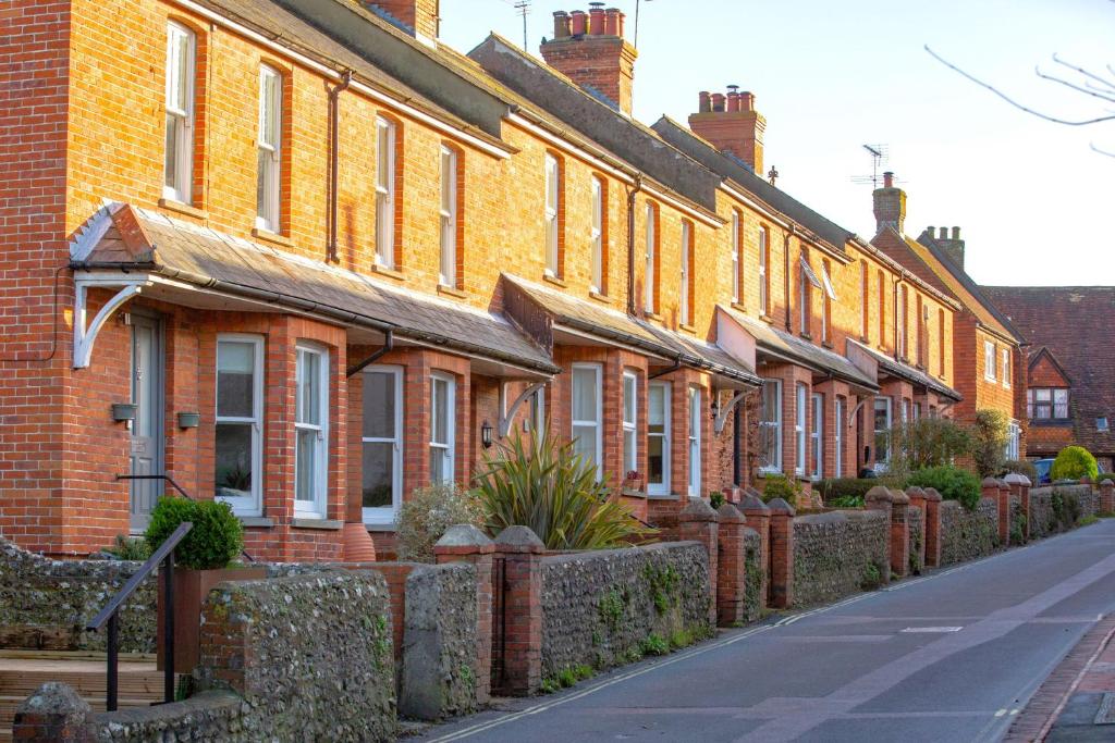 a row of brick houses on the side of a street at Bell Cottage in Alfriston