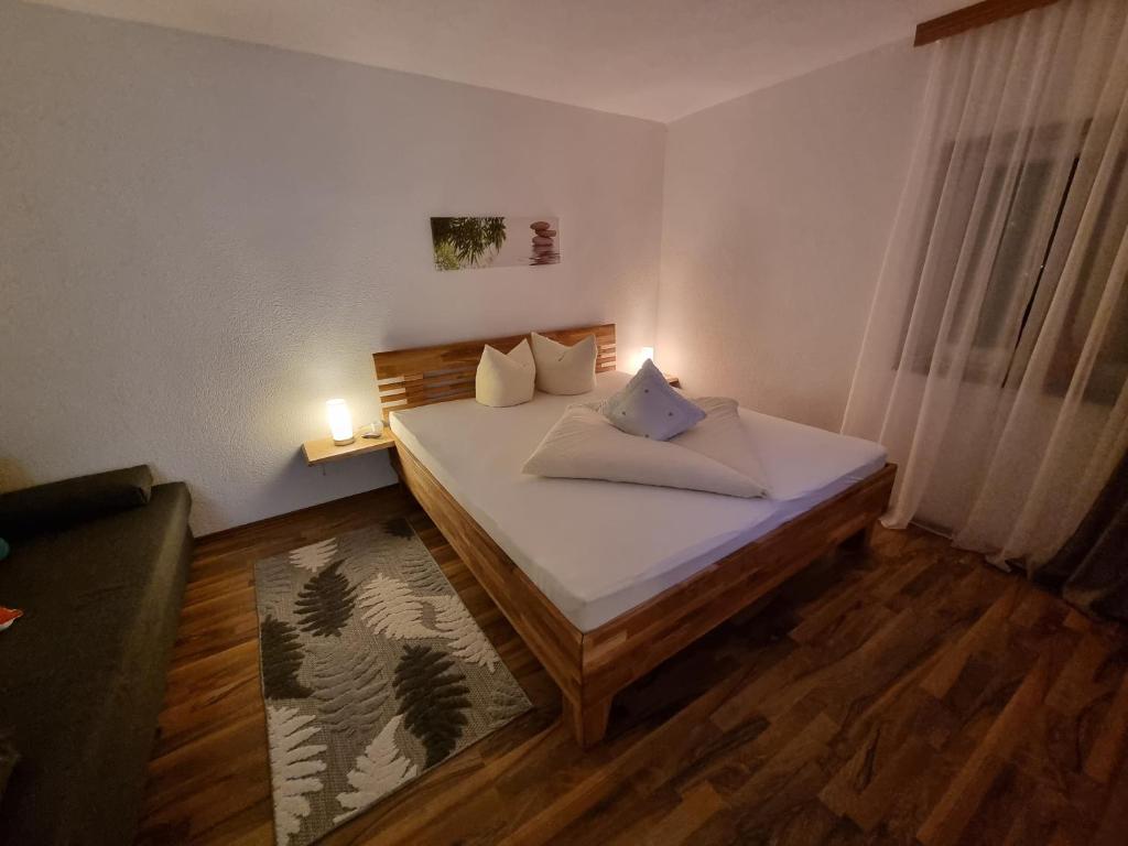 a bedroom with a bed with two candles on it at Haus Elena in Sautens