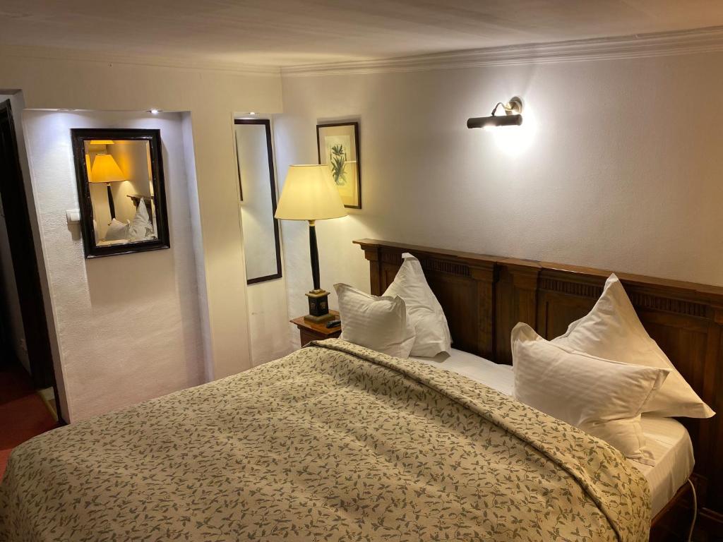 a bedroom with a large bed with white pillows at Apartamente Arcul de Triumf in Bucharest