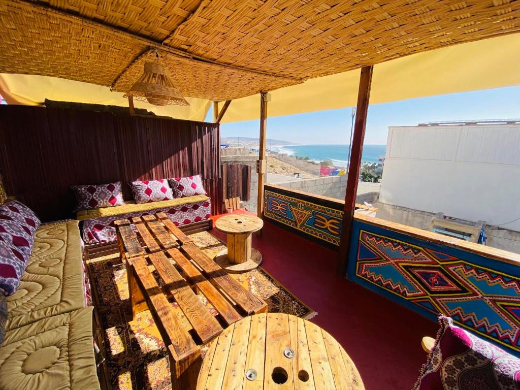 a living room with a couch and a table at Mabidi Surf Camp Morocco in Taghazout