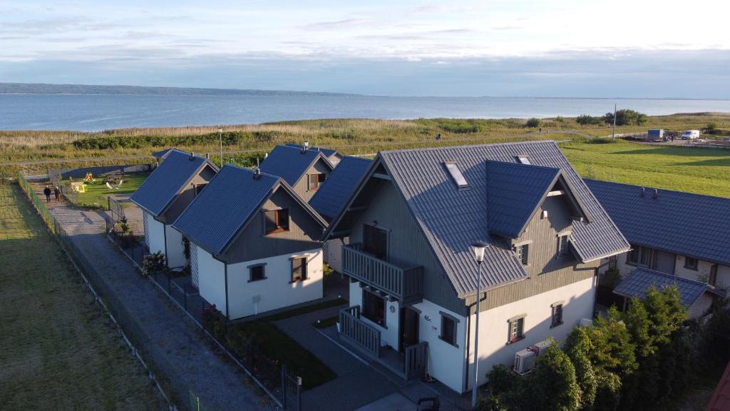 an aerial view of a house with blue roofs at Los Reyes II - klimatyzowane pokoje in Krynica Morska