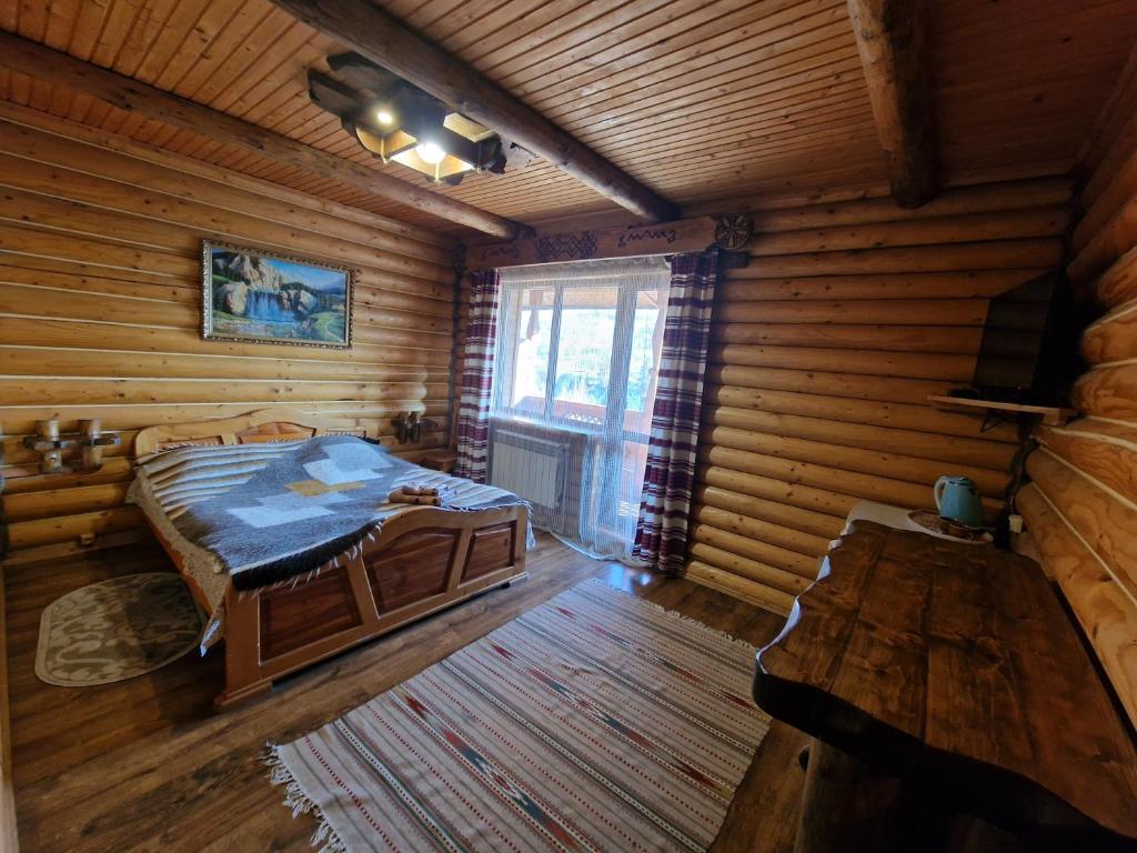 Postel nebo postele na pokoji v ubytování Гуцульська хата
