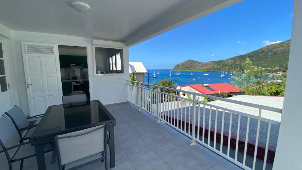 a balcony with a view of the ocean at Appartement vue mer Chez Ti Louis - Grande Anse in Les Anses-dʼArlets