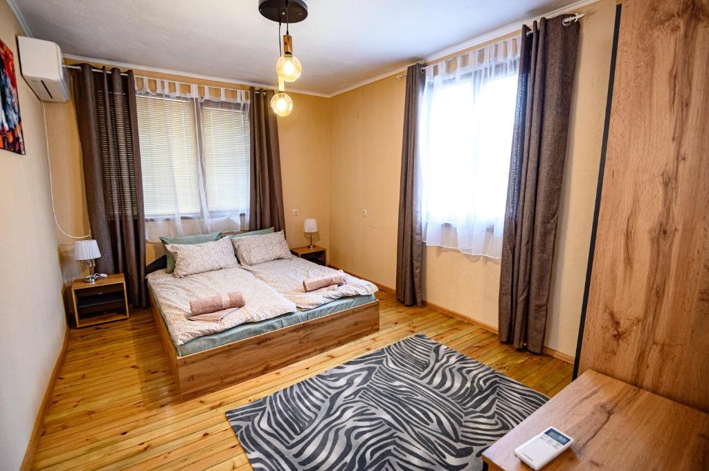 a bedroom with a bed and a zebra rug at Lalev Guest House in Bansko