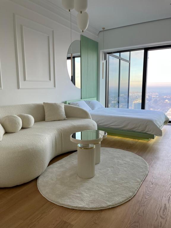 a living room with a couch and two beds at Sky Residence West 65 Tower in Belgrade