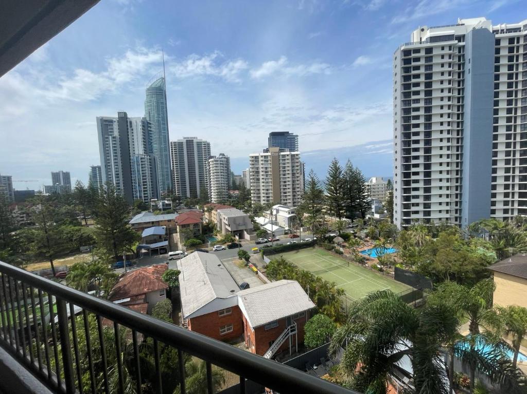 a balcony with a tennis court in a city at Aristocrat Apartments in Gold Coast