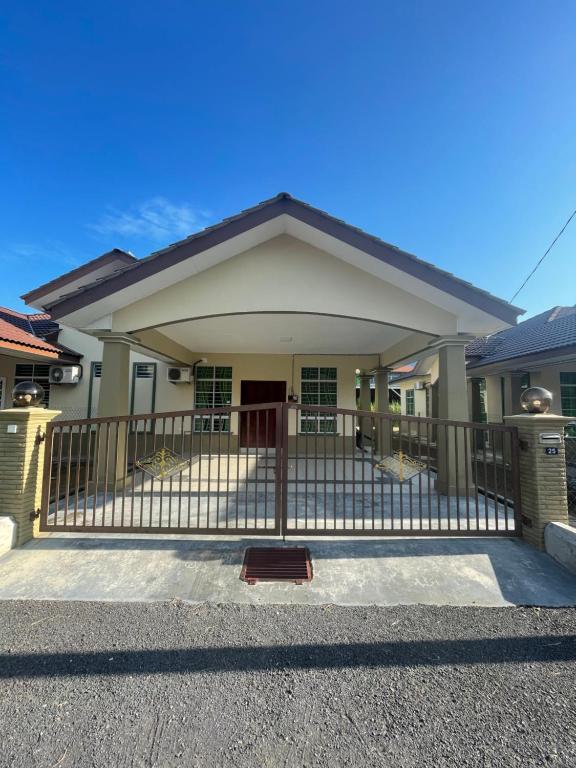 a house with a gate in front of it at TDH Homestay Arau FREE Wifi in Arau