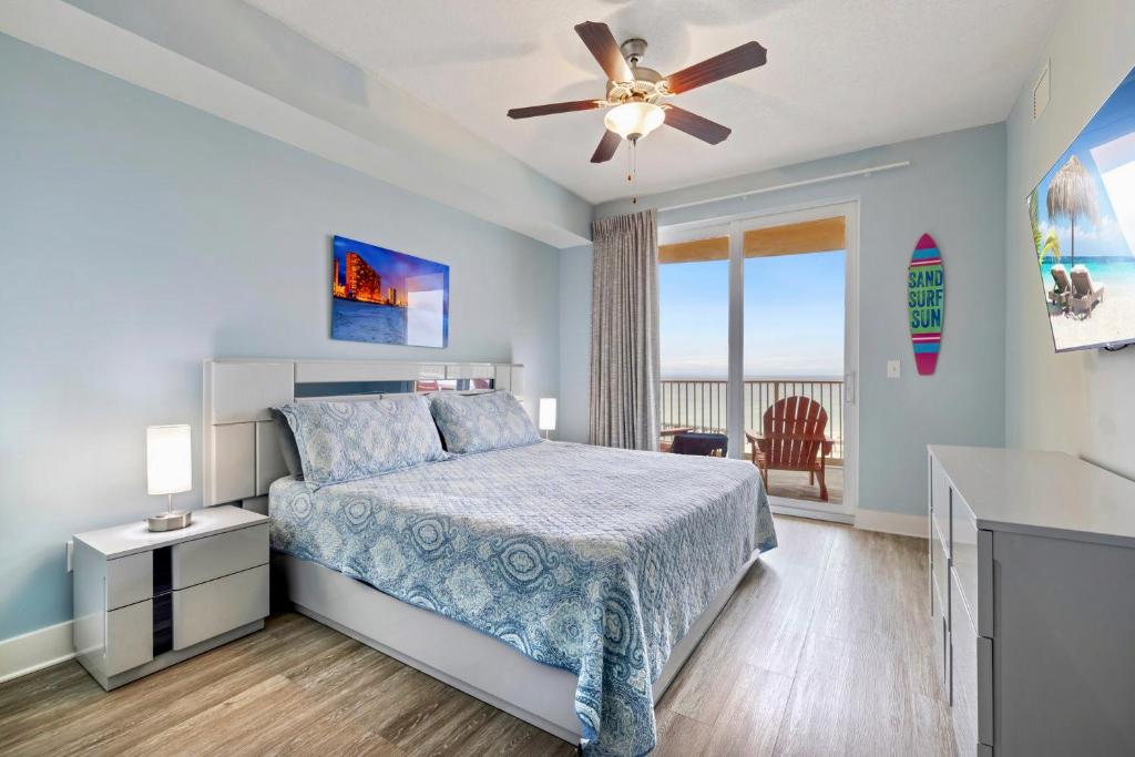 a bedroom with a bed and a ceiling fan at Brand New Calypso Resort Tower 3! Sleeps 9! Free Beach Chair Service! by Dolce Vita Getaways PCB in Panama City Beach