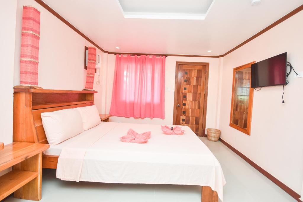 Postel nebo postele na pokoji v ubytování Nigi Nigi Too Beach Resort