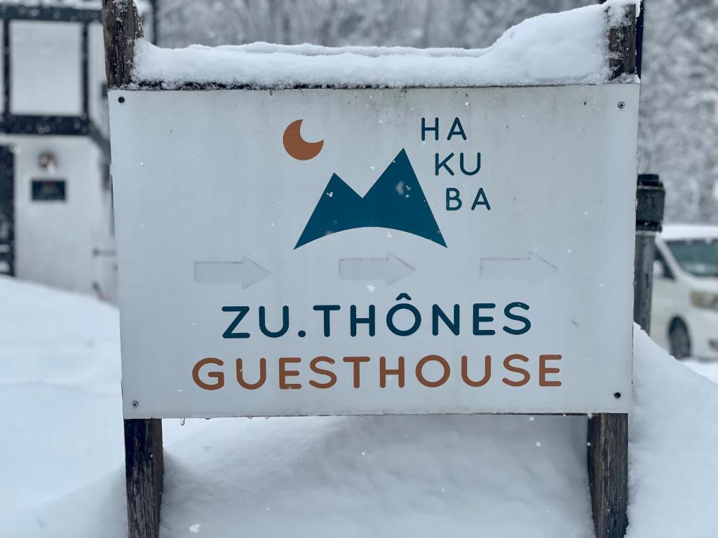 a sign for a zimbabwe guesthouse covered in snow at ZU-THONES HAKUBA ANNEX in Yotsuya
