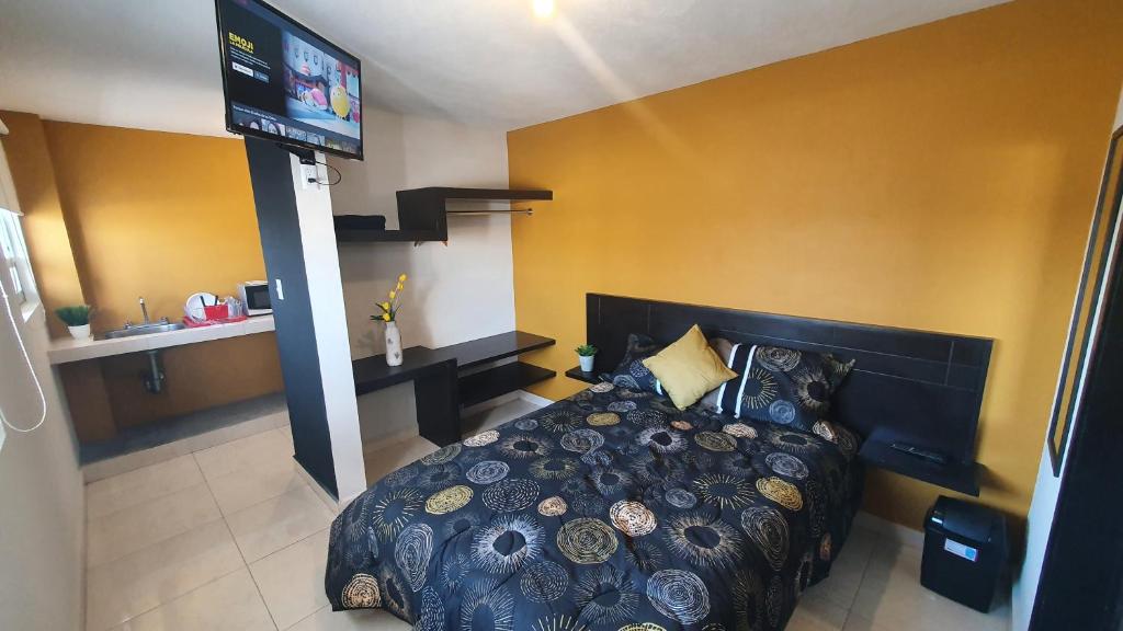 a bedroom with a bed and a flat screen tv at Departamentos fresno! Una excelente opción in Toluca