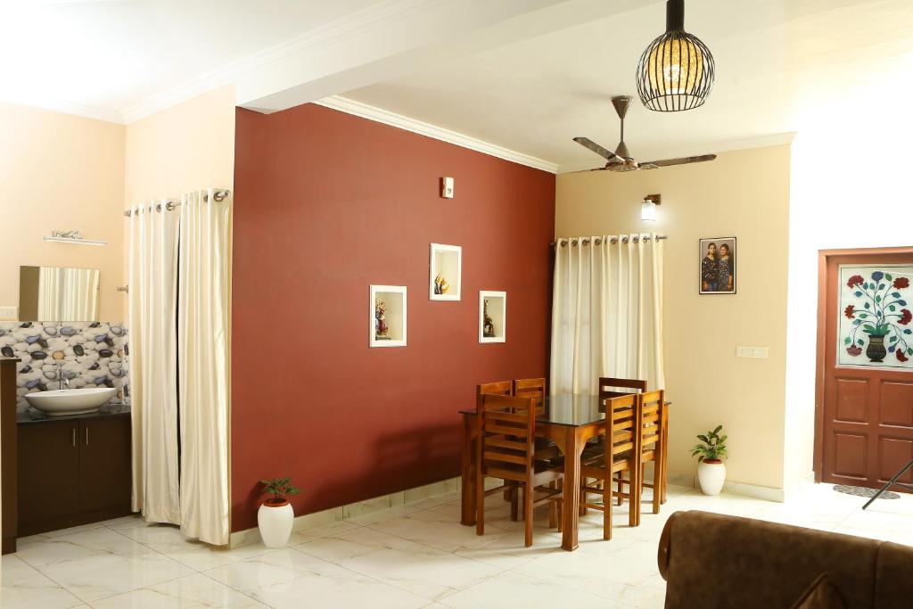 a living room with a table and a dining room at PAUL'S HOME STAY in Cochin