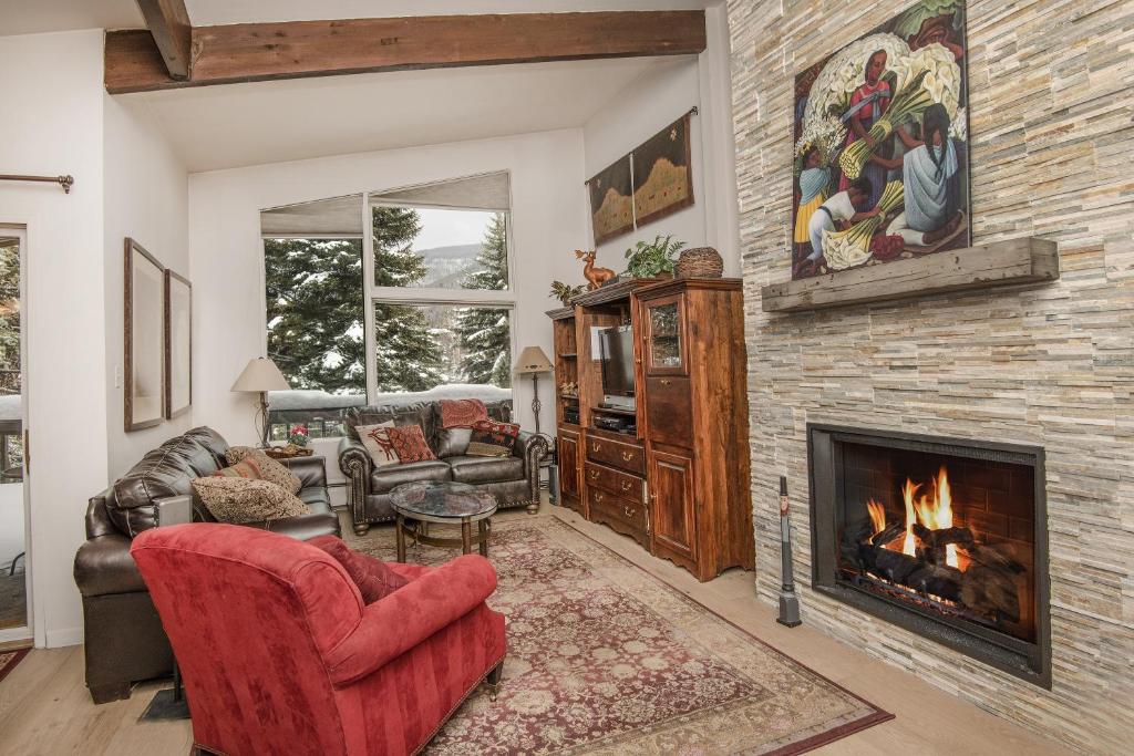 a living room with a fireplace and a couch at All Seasons G4 Condo in Vail