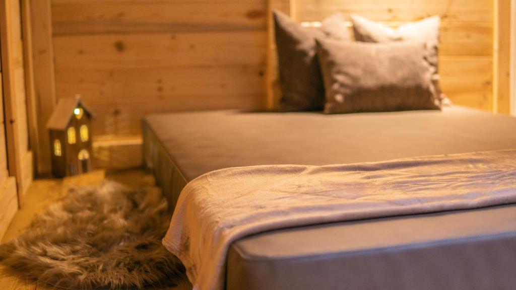 a bedroom with a bed with a furry pillow at ALPS LOVER in Campodenno
