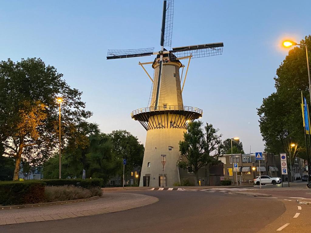 a windmill in the middle of a street at Hotel Cafe The Windmill in Schiedam