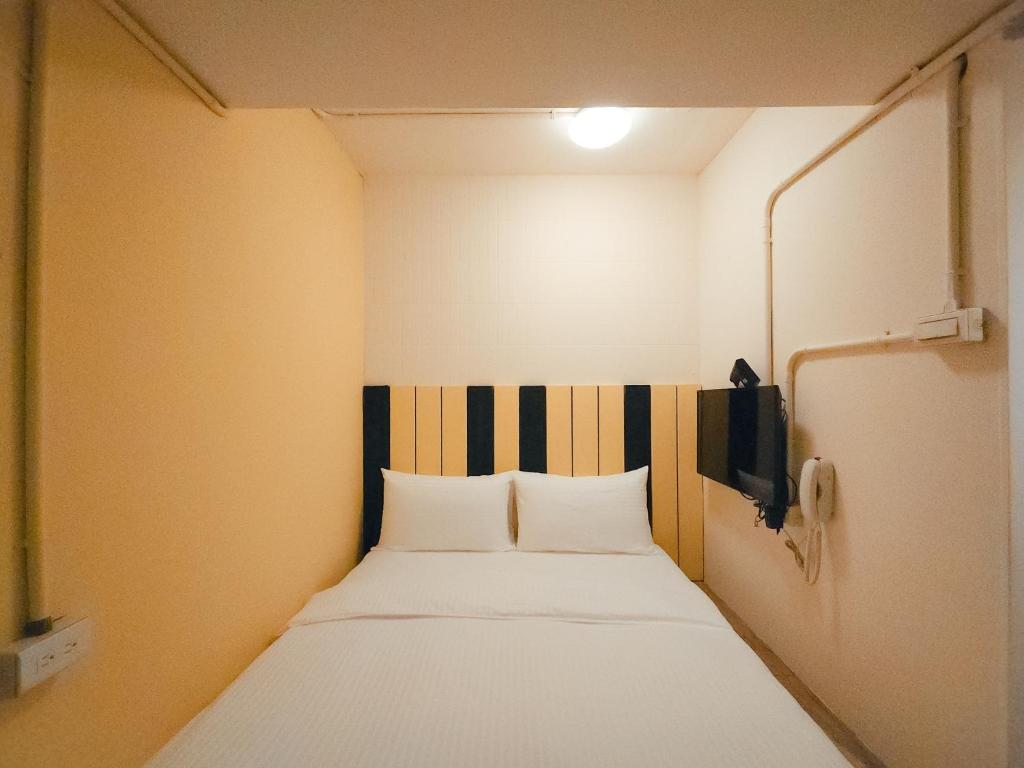 Postel nebo postele na pokoji v ubytování Taipei Inn