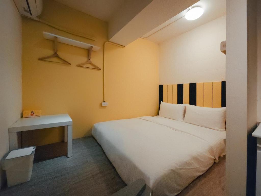 Postel nebo postele na pokoji v ubytování Taipei Inn