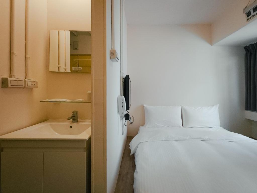 Postel nebo postele na pokoji v ubytování Taipei Inn