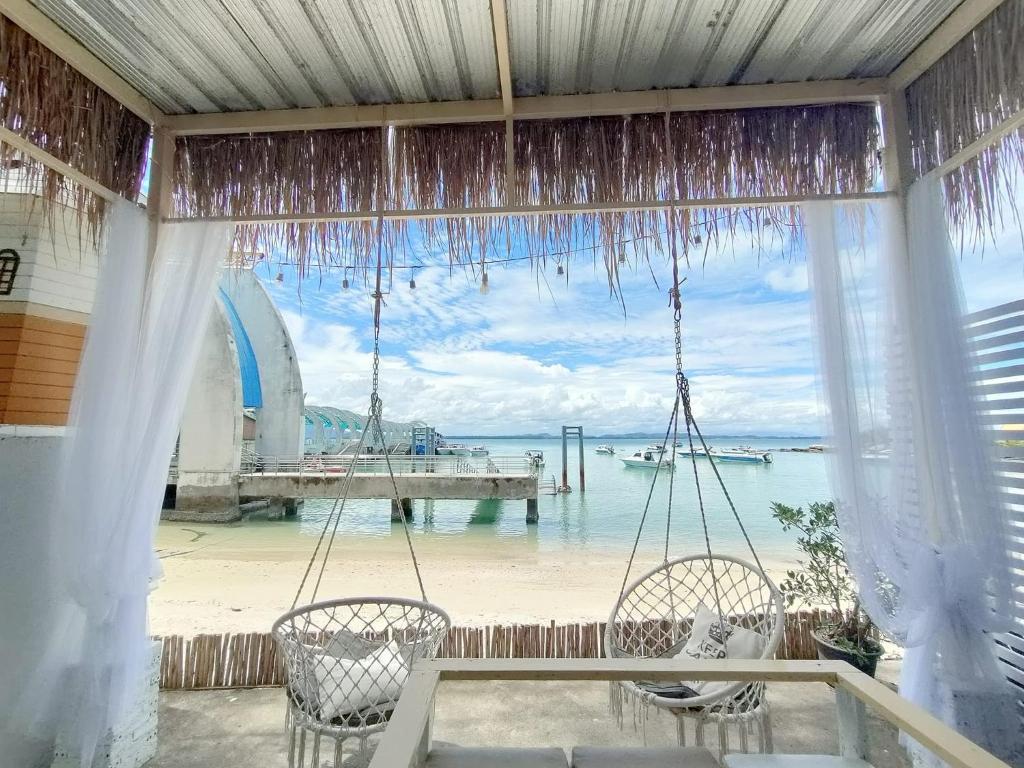 a porch with two chairs and a view of the ocean at I-Talay Zone Sea in Ko Samed