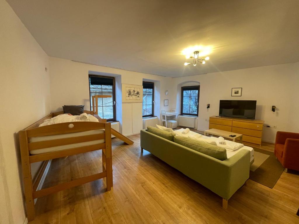 a living room with a couch and a television at Central Retro Apartment in Sibiu