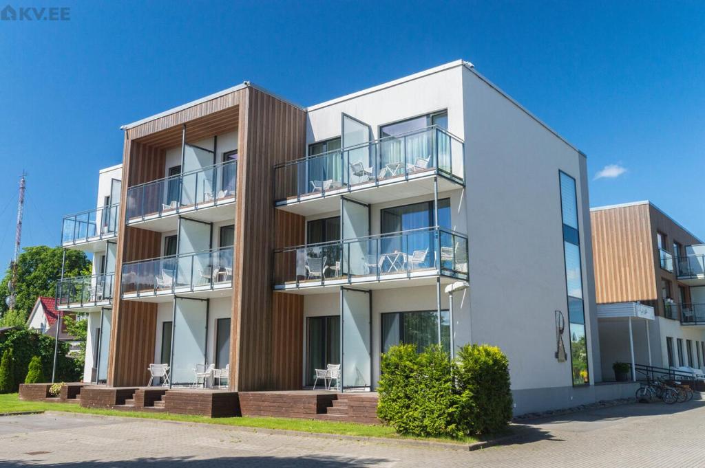 an apartment building with balconies on the side of it at Sunny Aisa Apartment in Pärnu