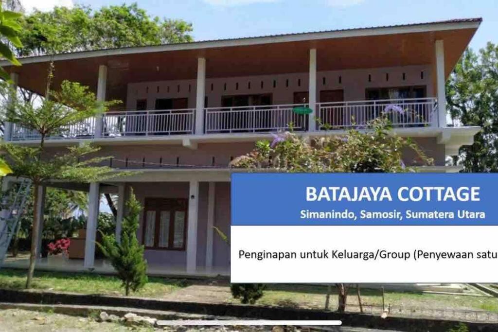 a building with a sign in front of it at Batajaya Cottage in Panjaitan