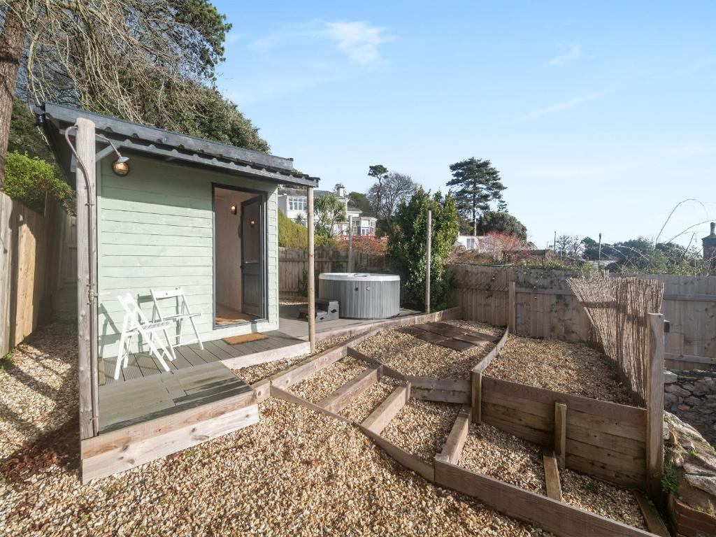 a backyard with a wooden deck and a house at The Lookout in Torquay