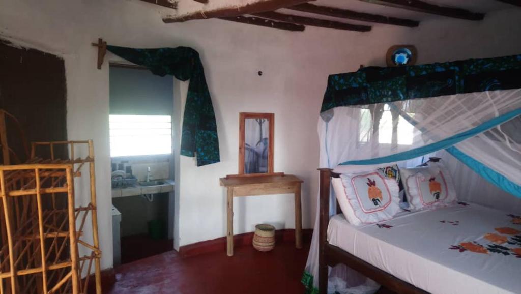 a bedroom with a bed with a canopy at Marashi Villa in Nungwi