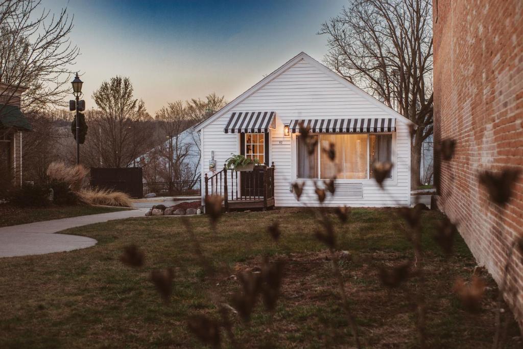 a white house with a window in a yard at The Free Spirit Retreat in Newaygo