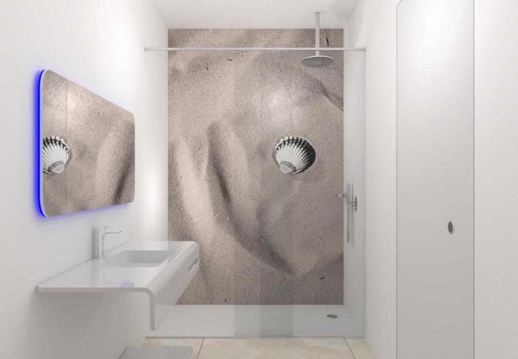 a bathroom with a sink and a shower at Unico Hotel Caorle in Caorle