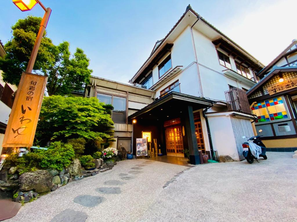 a building with a scooter parked in front of it at Iwayu in Misasa