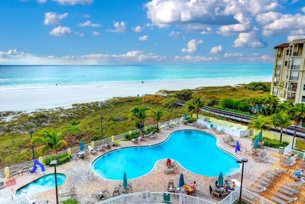 an aerial view of a resort with a swimming pool and the beach at Sunset Vistas 206S in St Pete Beach