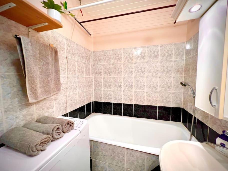 W łazience znajduje się wanna i umywalka. w obiekcie Pille Apartman w Segedynie