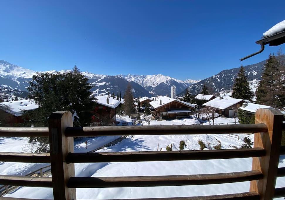 een uitzicht op een besneeuwde berg vanaf een houten hek bij Magnifique Ski in/out, cosy and calm, 4 bedrooms in Verbier