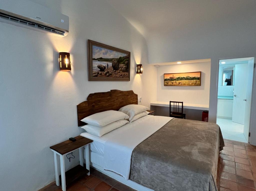 a bedroom with a large white bed in a room at OceanBlue Resort in Christ Church