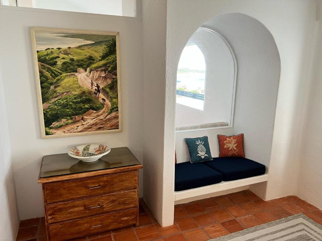 a room with a bench next to a window at OceanBlue Resort in Christ Church