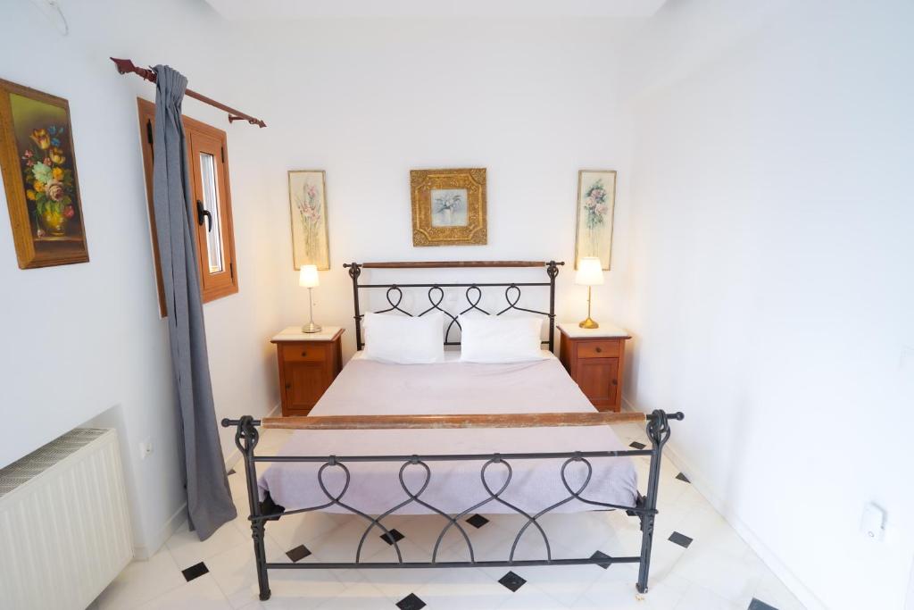 a bedroom with a bed with two lamps on either side at Fira Central Apartments with Veranda in Fira